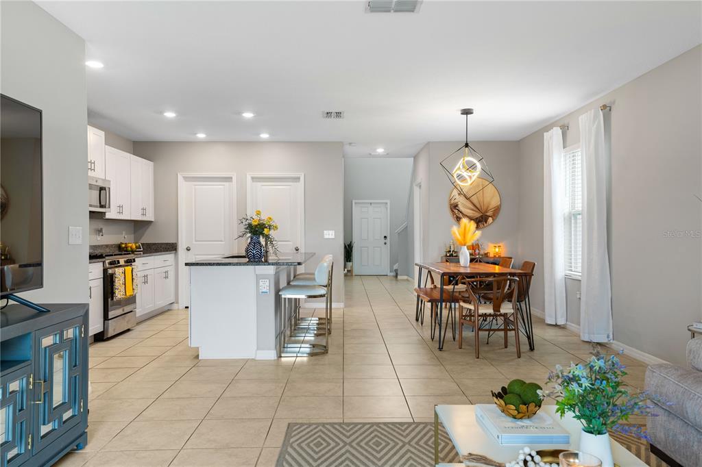 9448 Lemon Drop Loop Ruskin, FL 33573 - Photo 6 of 28 a living room with furniture a dining table and chairs