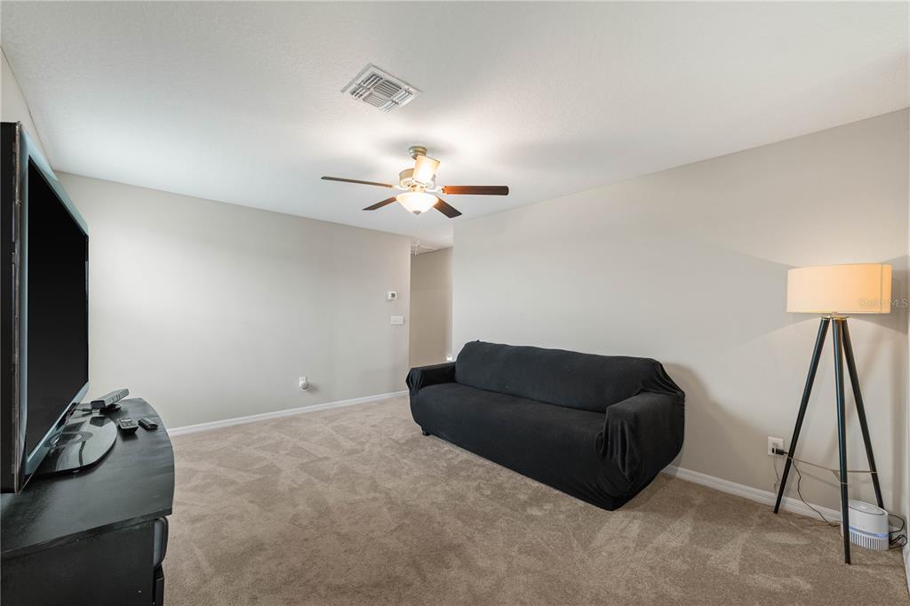 9448 Lemon Drop Loop Ruskin, FL 33573 - Photo 8 of 28 a living room with furniture and a flat screen tv