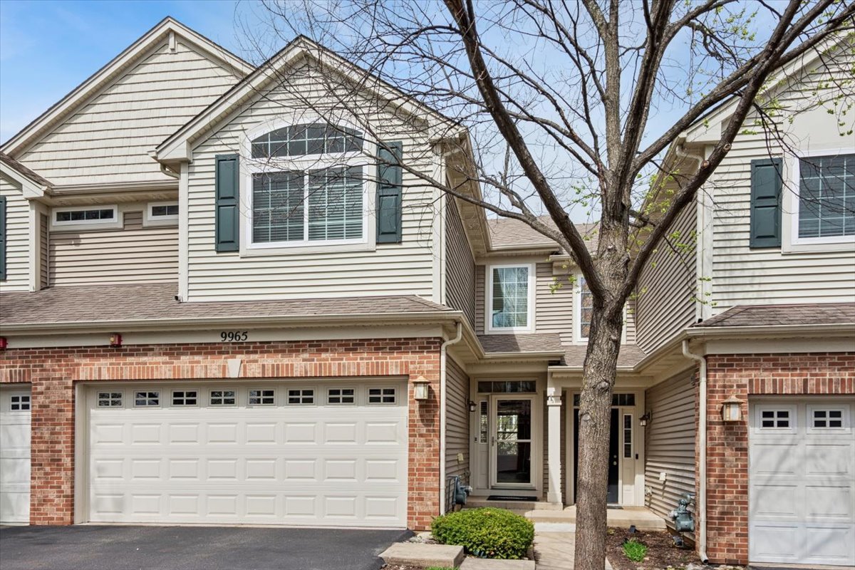 9965 Cummings Street Huntley, IL 60142 - Photo 1 of 23 a front view of a house with a tree