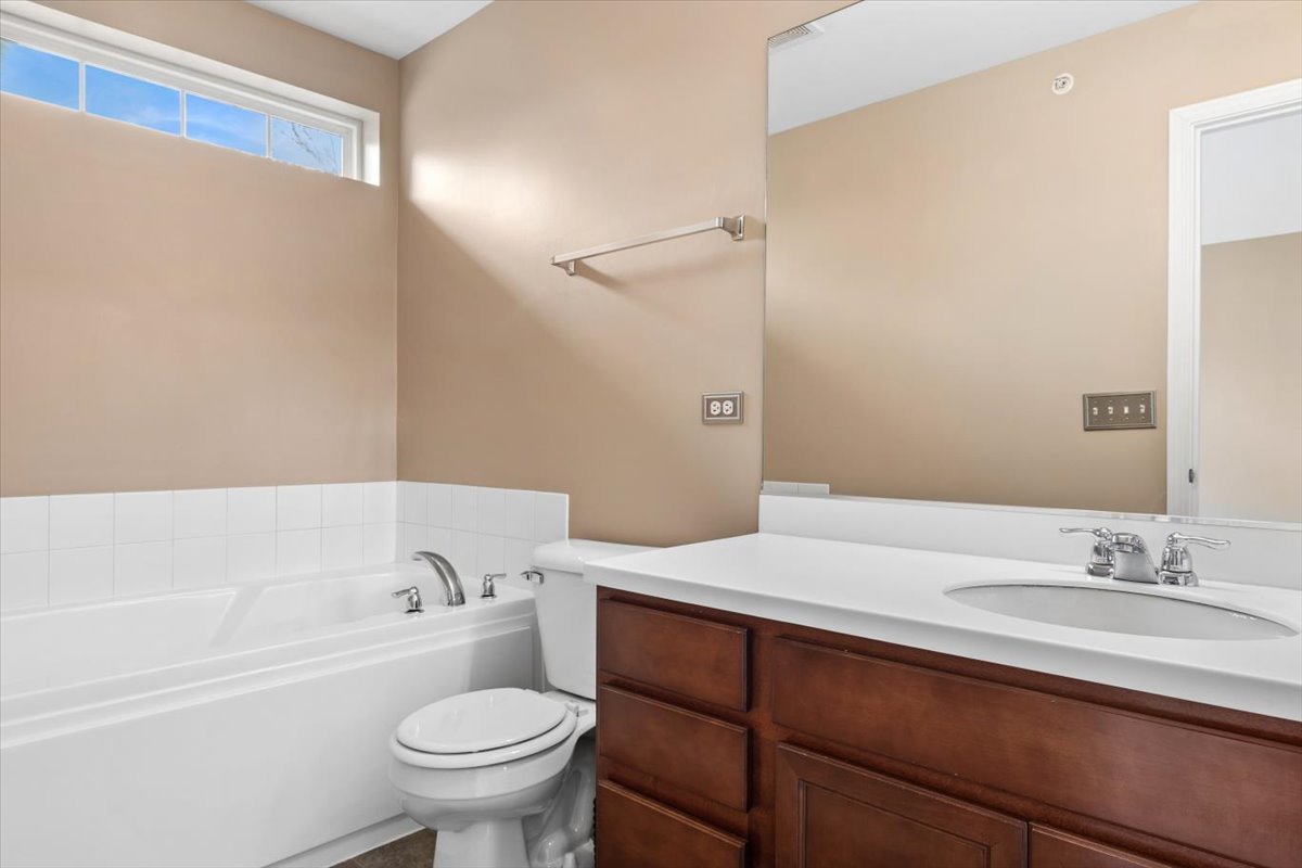 9965 Cummings Street Huntley, IL 60142 - Photo 18 of 23 a bathroom with a sink a toilet and a bathtub
