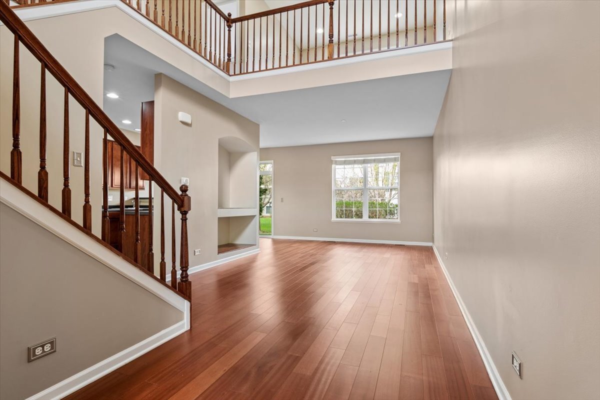 9965 Cummings Street Huntley, IL 60142 - Photo 2 of 23 wooden floor in an empty room with a window