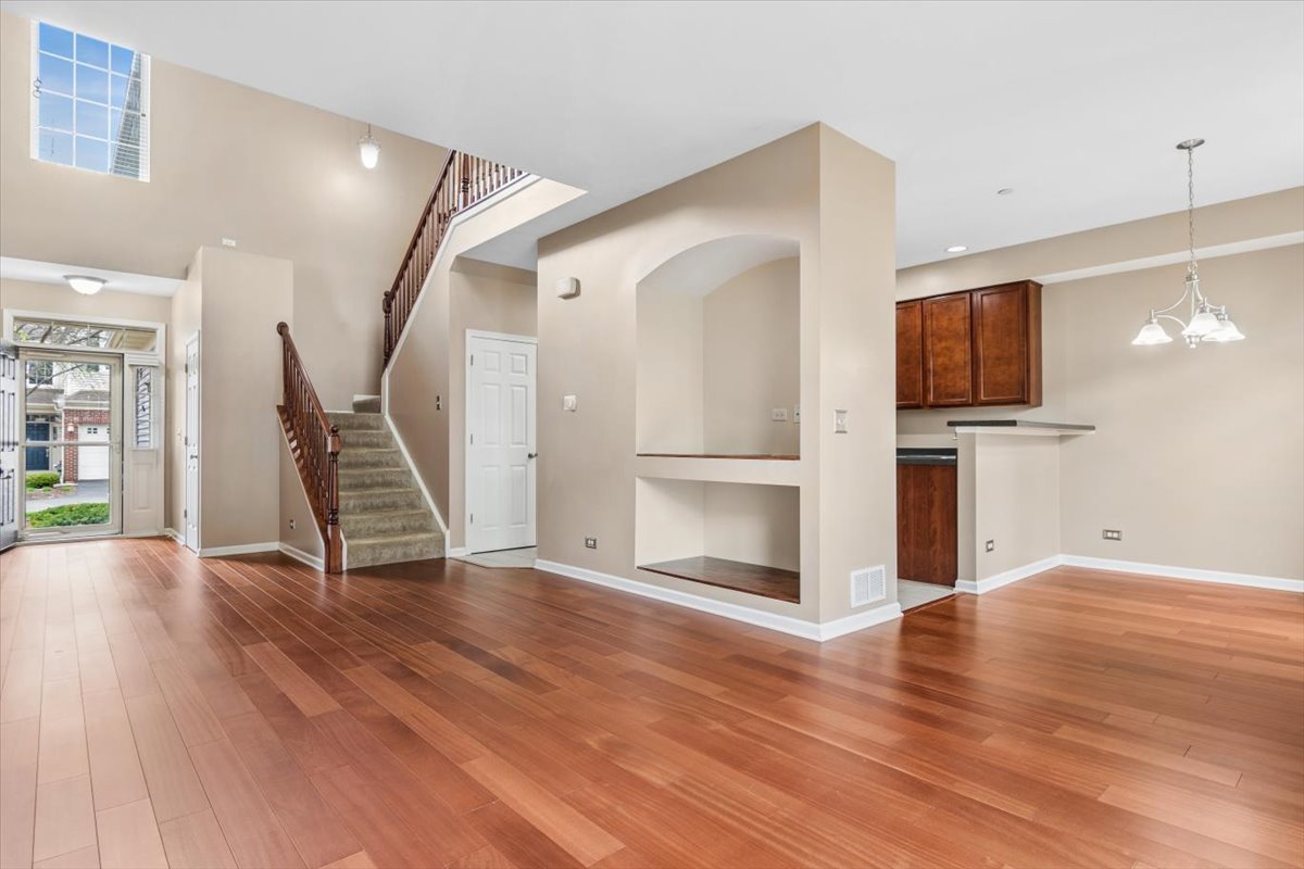 9965 Cummings Street Huntley, IL 60142 - Photo 4 of 23 a view of a livingroom with wooden floor and staircase