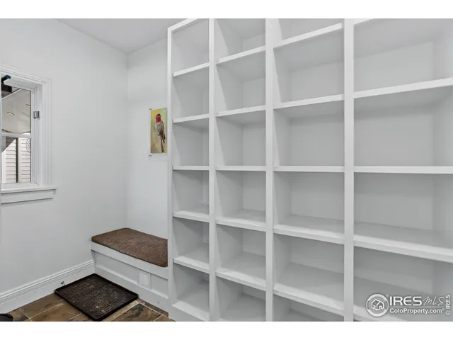 a living room with a bed and a window