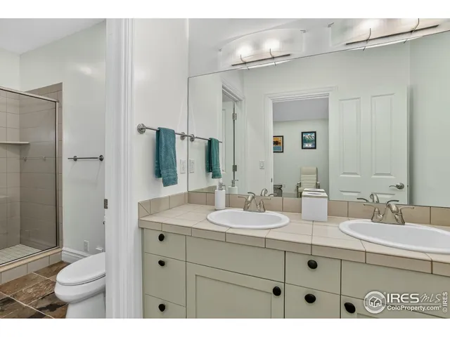 a bathroom with a sink double vanity and a toilet