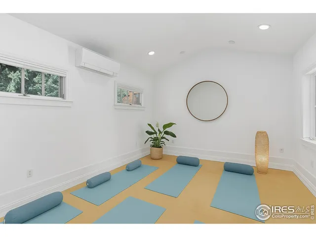 a bedroom with a bed mirror and a window