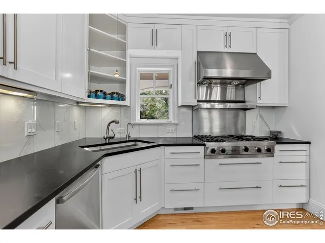 a kitchen with stainless steel appliances granite countertop a sink stove and cabinets