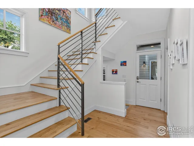 a view of entryway and hall with wooden floor