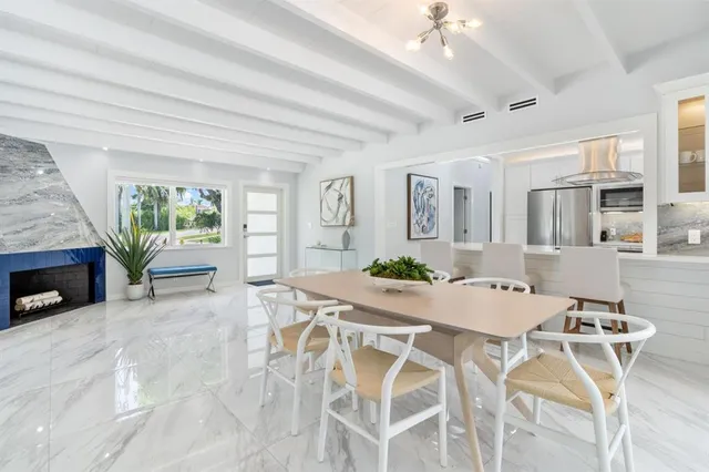a view of a dining room with furniture and a chandelier