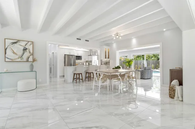 a view of a dining room with furniture and a chandelier