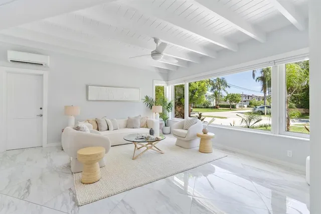 a living room with furniture and a floor to ceiling window