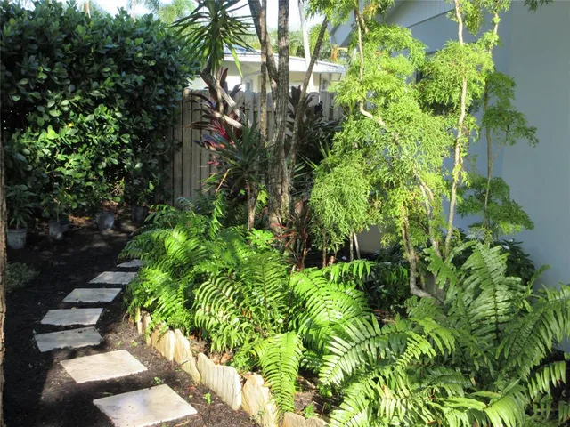 an aerial view of a house with a yard and potted plants