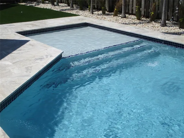 a view of swimming pool with a patio
