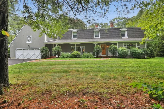a front view of house with yard and green space