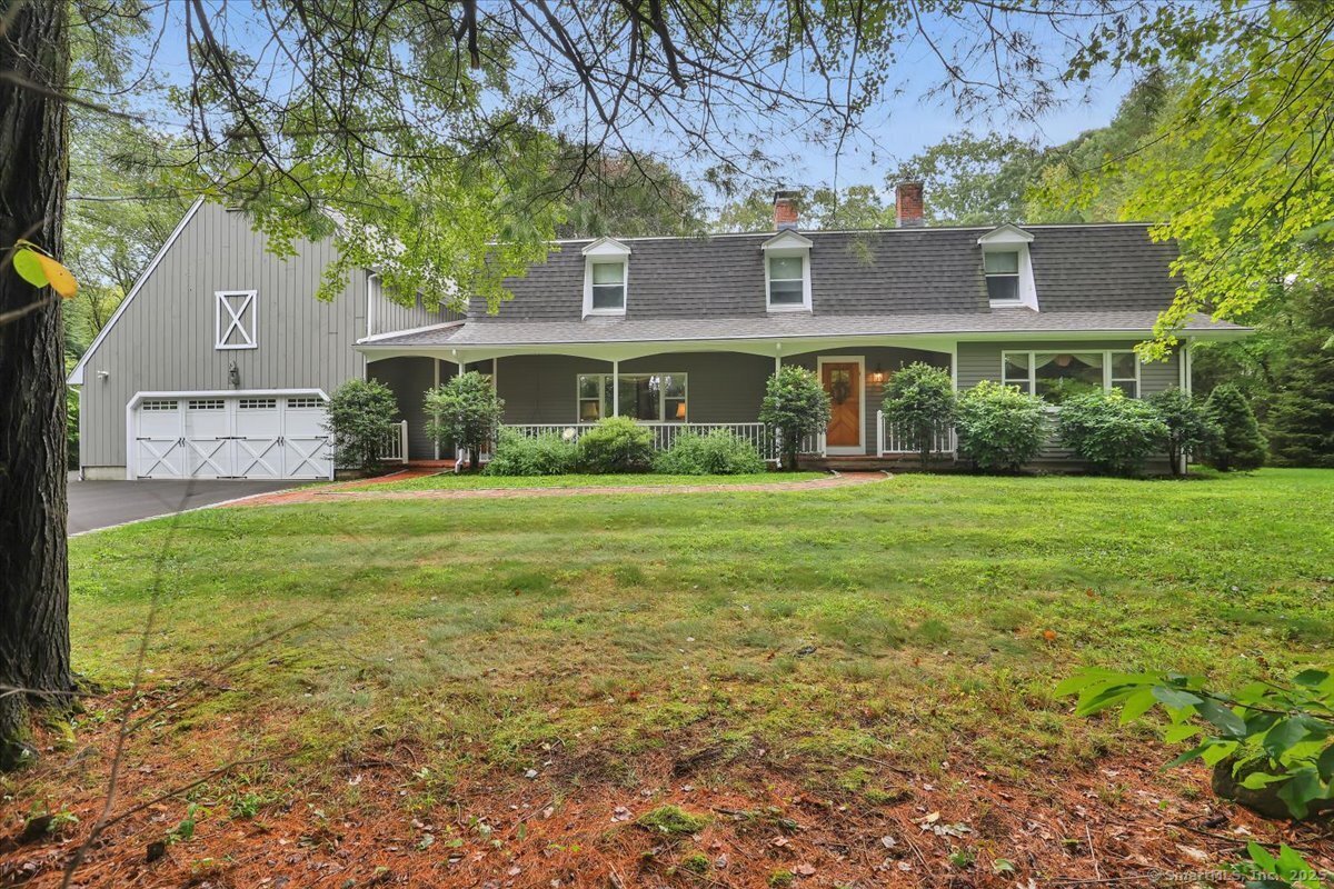 a front view of house with yard and green space