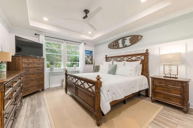 a bedroom with a bed and a flat tv screen on dresser