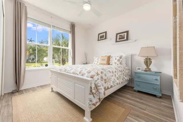 a bedroom with a bed lamp and window