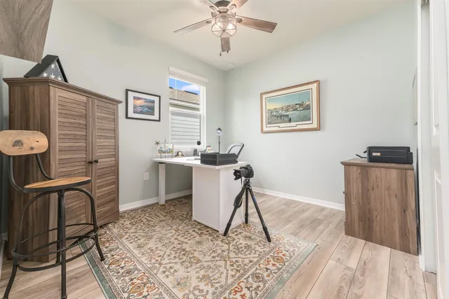 a view of workspace with wooden floor and cabinet