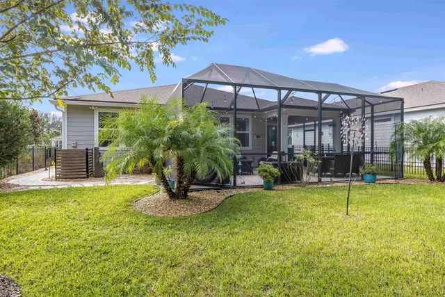 a view of a swimming pool with a patio and a yard
