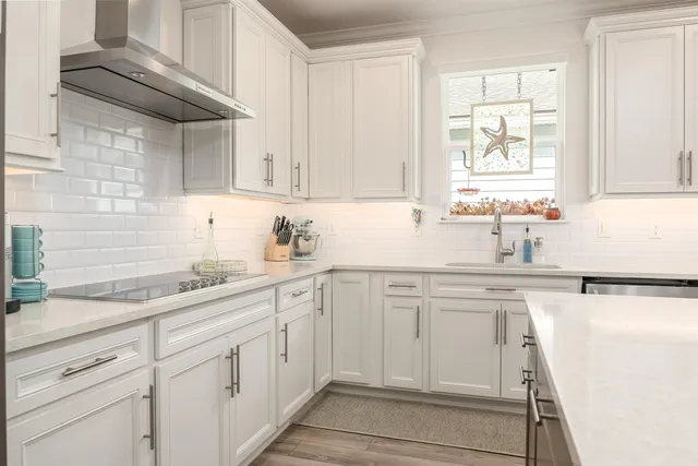 a kitchen with white cabinets and white appliances