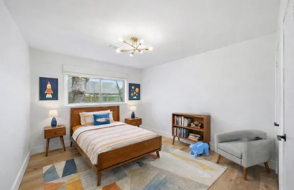 a bedroom with a bed a couch and dresser