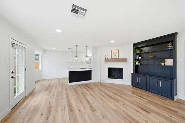 a view of kitchen and hall with wooden floor