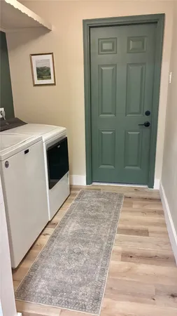 a view of a hallway with washer and dryer
