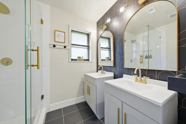 a bathroom with a double vanity sink mirror and