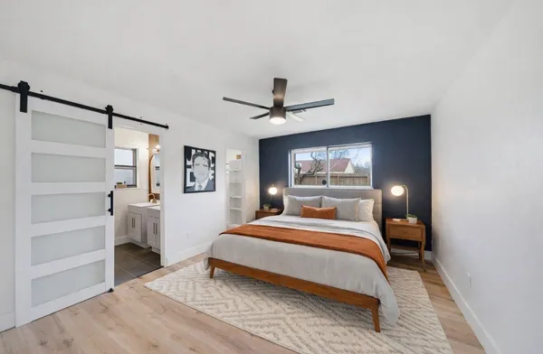 a bedroom with a bed and a chandelier