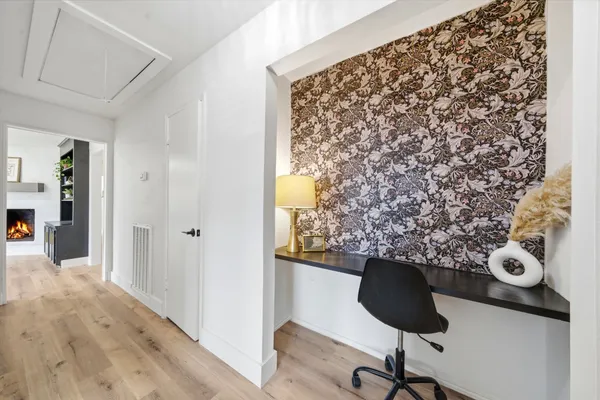 a view of entryway with workspace and wooden floor
