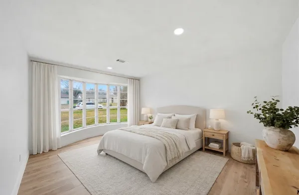 a bedroom with a large bed and a large window