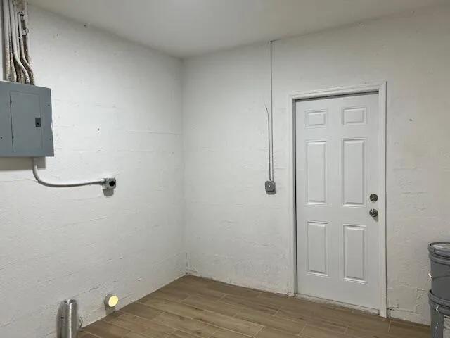 a view of a room with wooden floor