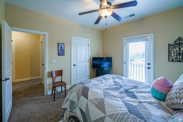 3683 South 2640 West St. George, UT 84790 - Photo 28 of 41 Carpeted room featuring a ceiling fan with light fixture, light beige wall paint, white trim, and a white door with a black handle