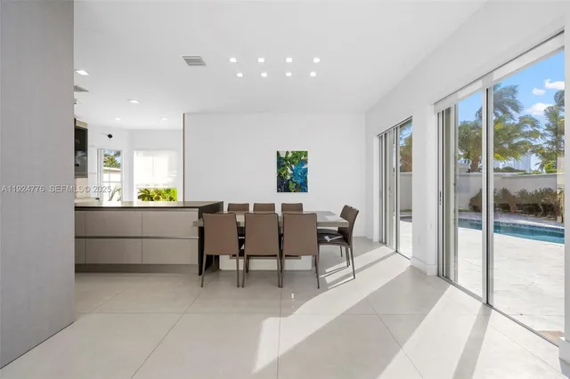 a living room with furniture a rug and a large window