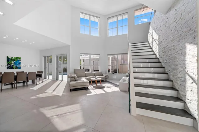 a living room with furniture and stairs