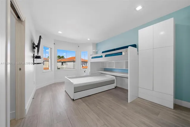 a view of game room with wooden floor and furniture