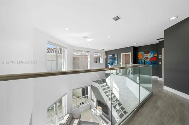 a view of a living room with furniture and a flat screen tv