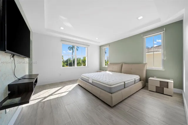 a bedroom with a bed and a flat screen tv