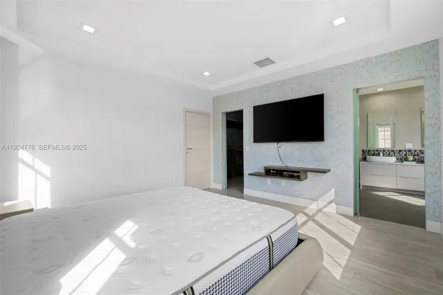 a bedroom with a bed and a flat screen tv