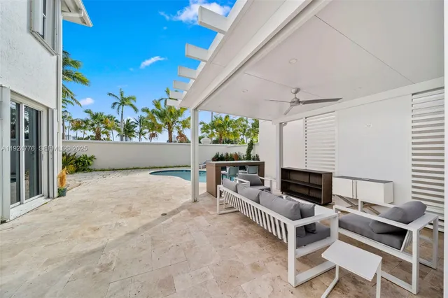 a living room with furniture a fireplace and a potted plant