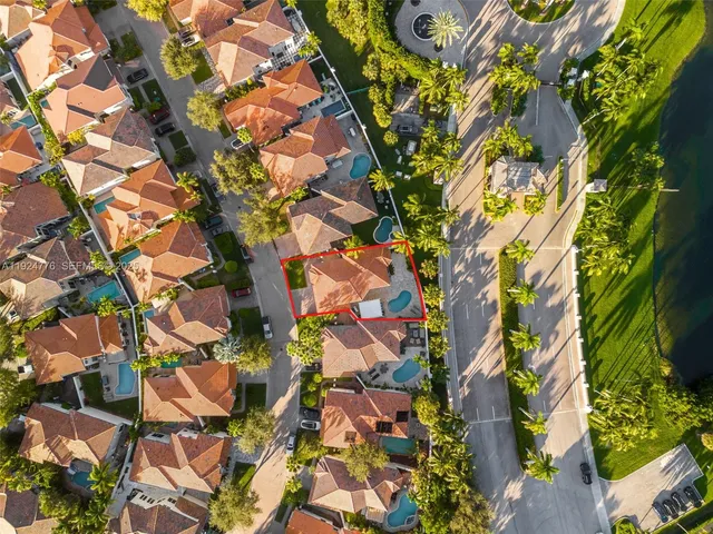 an aerial view of residential houses with outdoor space and street view
