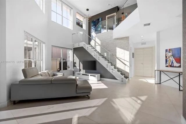 a living room with furniture and stairs