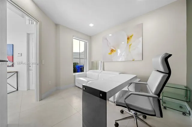 a view of a workspace with furniture and window