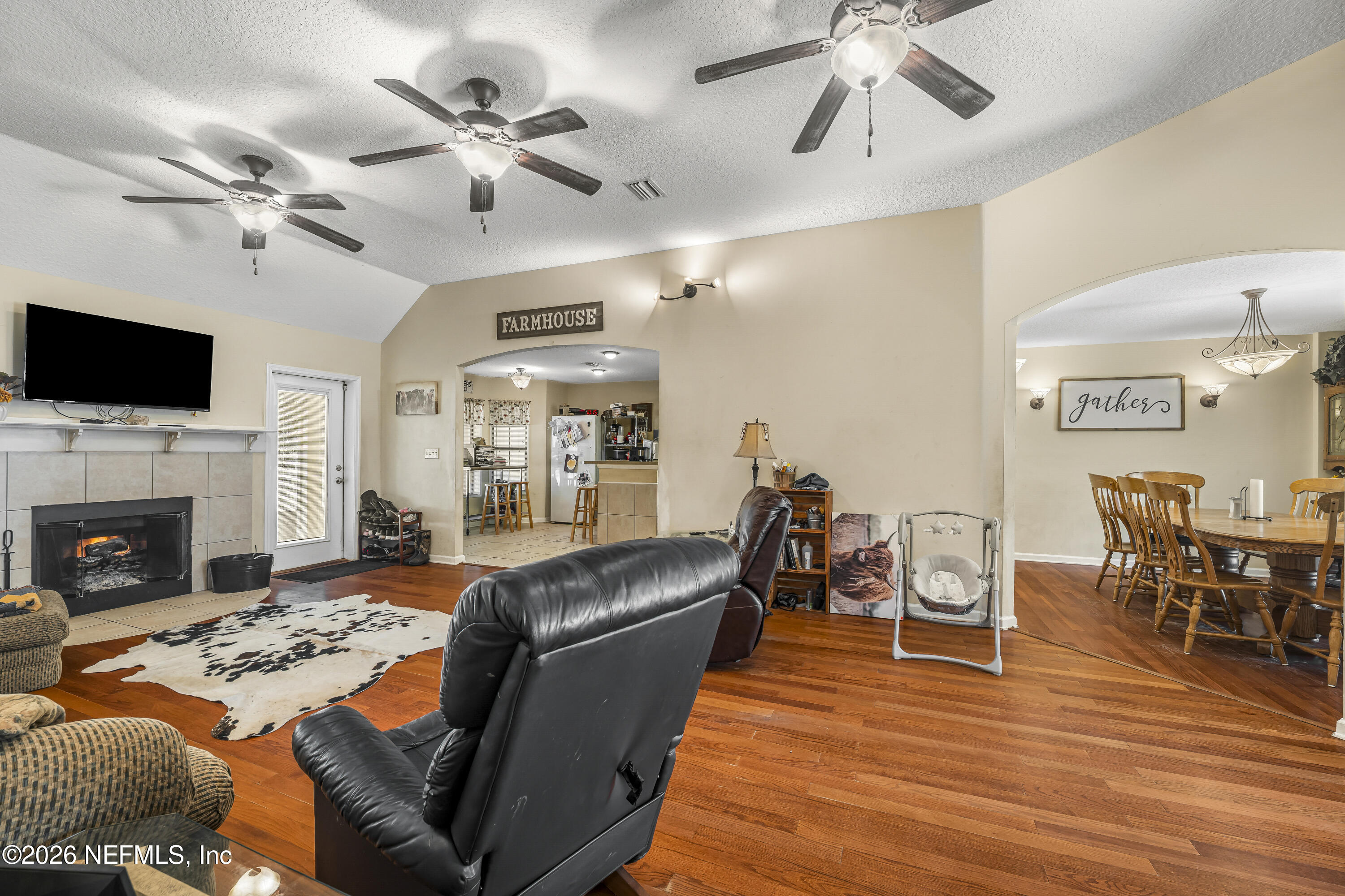 1725 Davidson Farm Road Jacksonville, FL 32218 - Photo 18 of 53 a living room with furniture fireplace and flat screen tv
