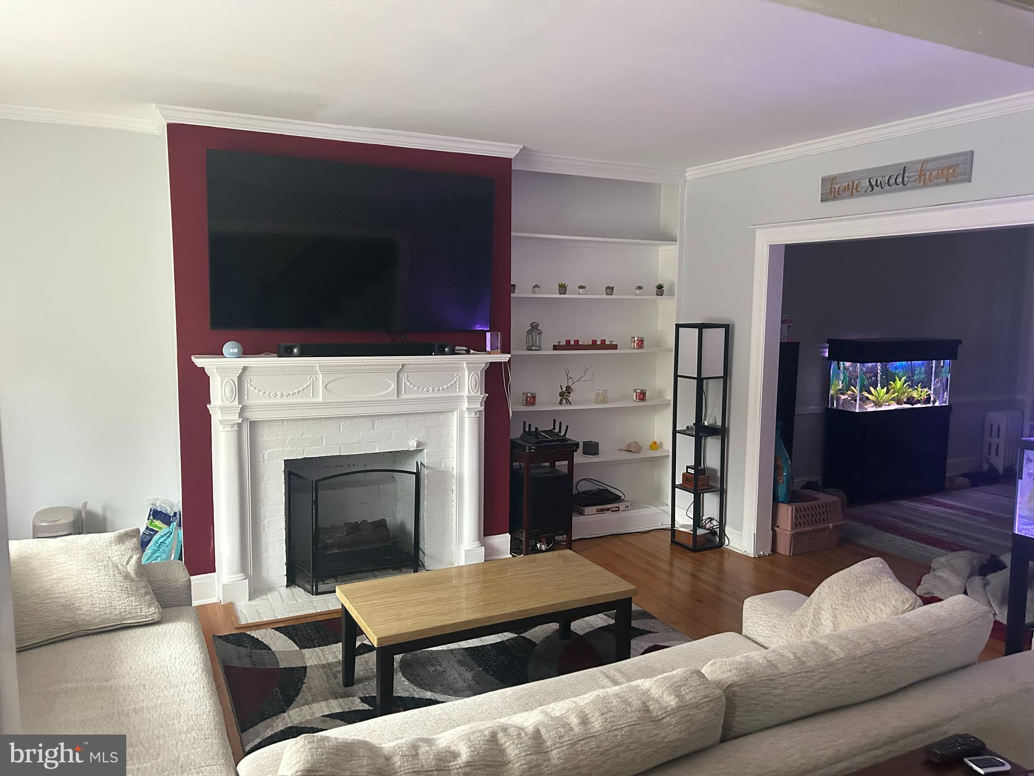 4211 Wickford Road Baltimore, MD 21210 - Photo 3 of 16 a living room with furniture a flat screen tv and a fireplace