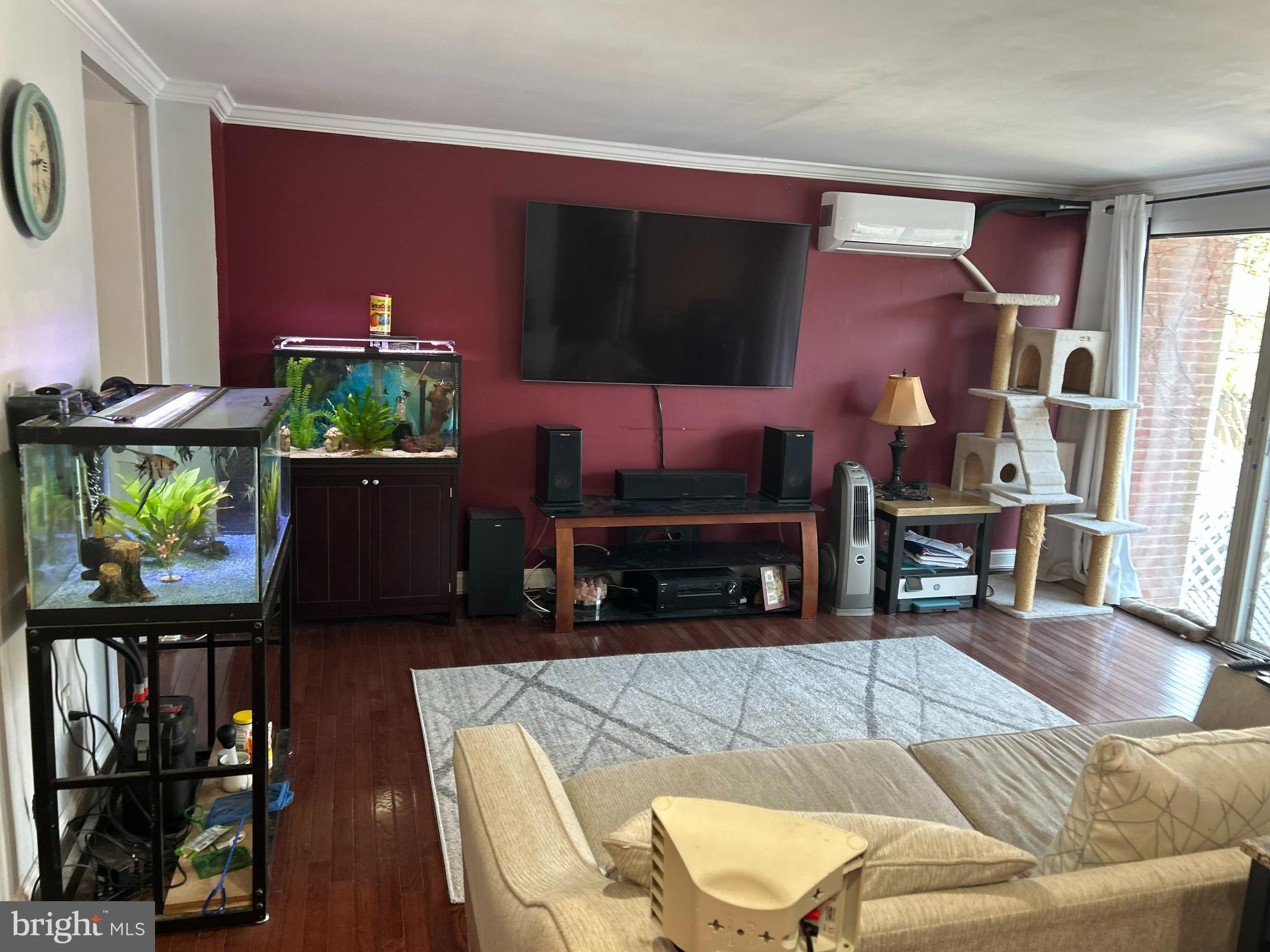 4211 Wickford Road Baltimore, MD 21210 - Photo 10 of 16 a living room with furniture a flat screen tv and a floor to ceiling window