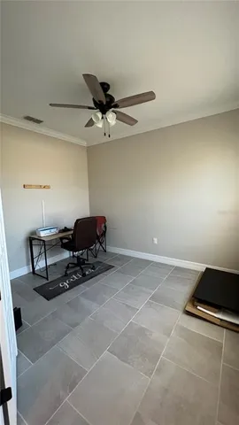 a living room with furniture and a ceiling fan