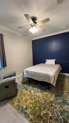 a bedroom with a bed and a couch