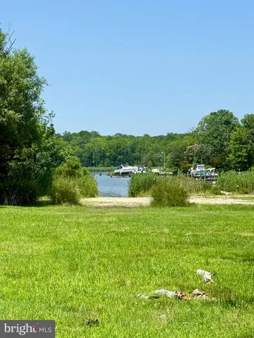 a view of a lake with houses in the back