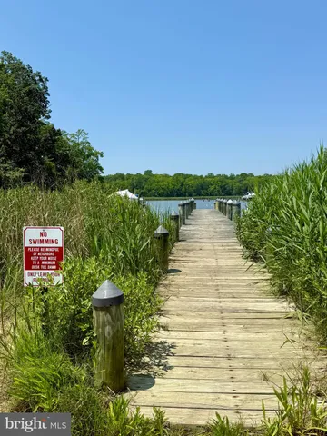 a view of a lake with a floor to ceiling window and a lake view