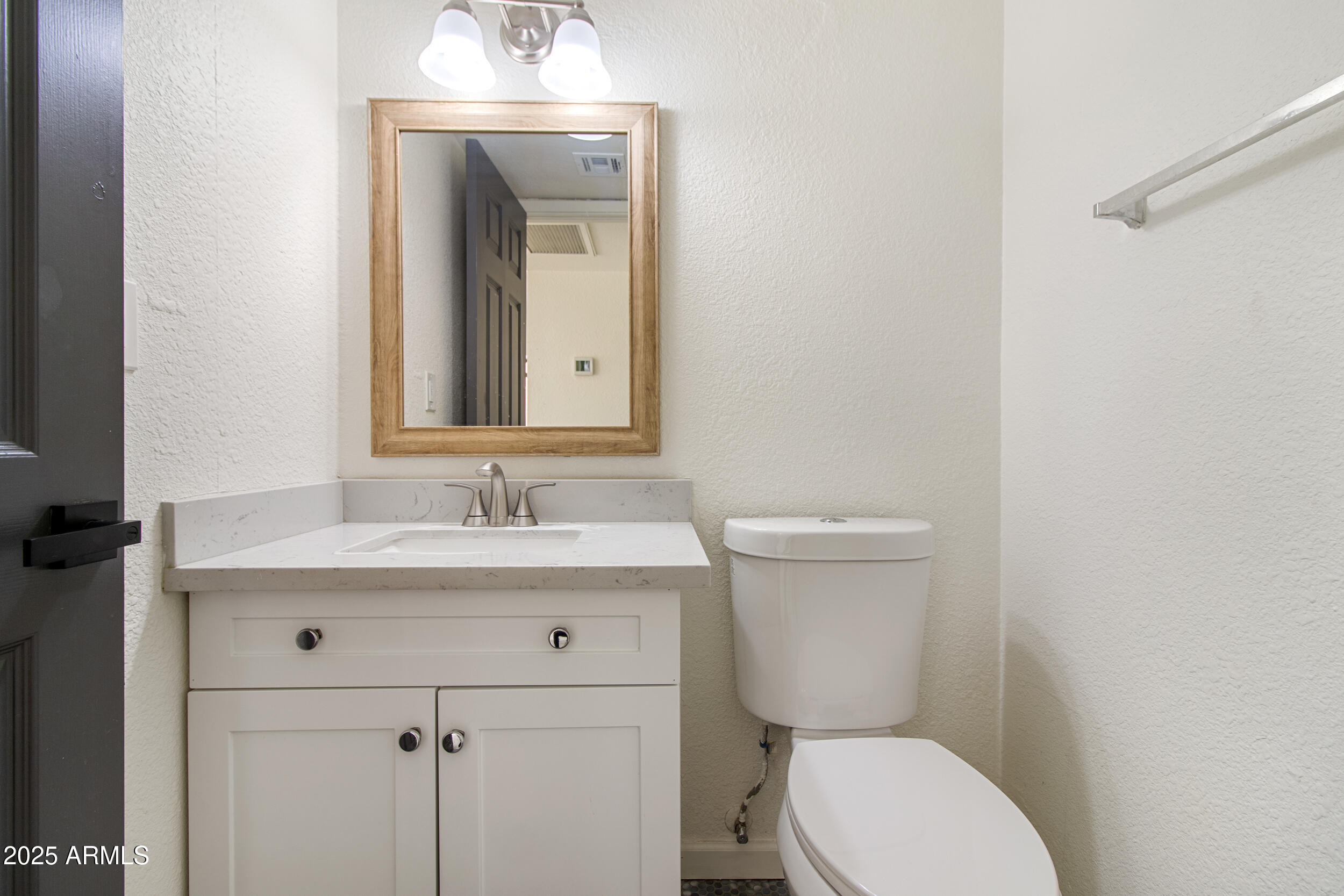 2500 North Hayden Road, Unit 15 Scottsdale, AZ 85257 - Photo 12 of 34 a bathroom with a toilet a sink and mirror
